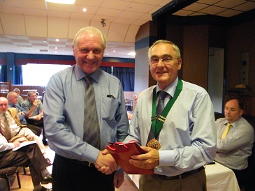 Jim Shaw receiving a momento from the new Chairman Terry Pateman
